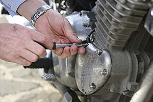 A biker adjusting his motorcycle