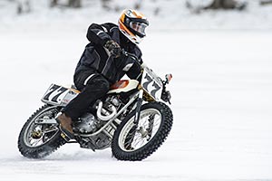 A motorcyclist taking a spin during a cold wintery day