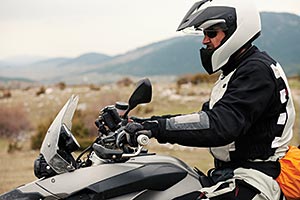 A motorcyclist taking a spin during a cold wintery day