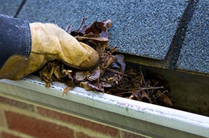 Spring home inspection checklist A mobile home owner cleaning out gutters