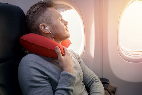 A person relaxing with music while in plane